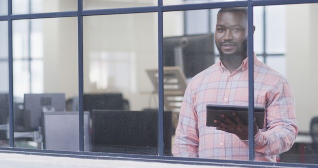 Confident Businessman Holding Digital Tablet by Office Window - Download Free Stock Images Pikwizard.com