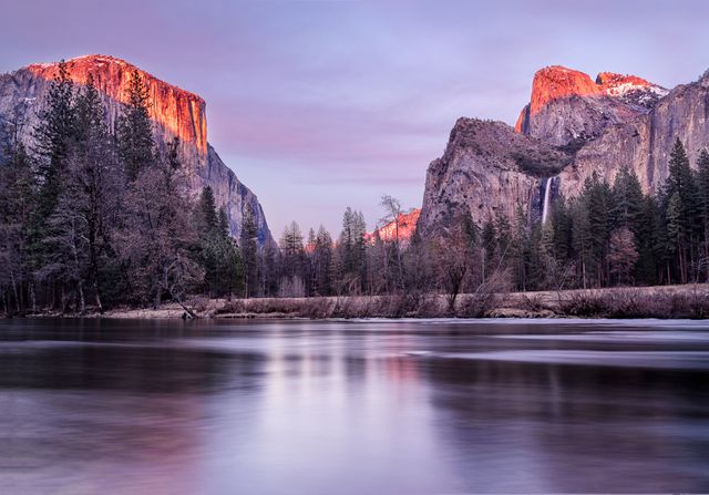 Scenic view of Yosemite Valley at sunset, highlighting the reflection of El Capitan and surrounding mountains in calm waters of Merced River. Perfect for use in nature-themed calendars, travel brochures, and as a desktop background to inspire wanderlust and appreciation for natural beauty.