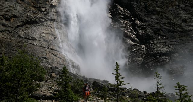 Hiker Enjoying Scenic Waterfall in Mountain Environment - Download Free Stock Images Pikwizard.com