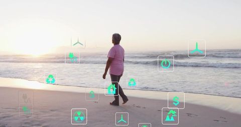 Senior woman walking on sunrise beach while sustainability and renewable energy icons float