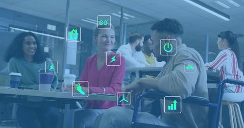 Inclusive team collaborating in office lounge with wheelchair and green energy icons