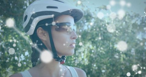 Woman Wearing Helmet and Sunglasses in Nature Amid Molecular Overlay