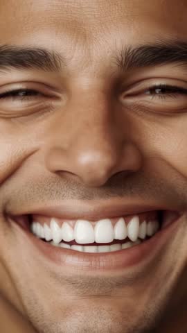 Vertical studio video showing man laughing, smiling and returning to smile while driving