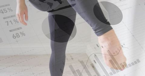 Woman stretching and reaching foot in studio with fitness data overlays tracking mobility