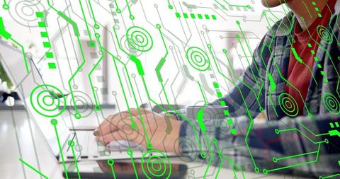 Typing on Laptop with Futuristic Green Circuit Overlay for Cybersecurity, Data and Tech