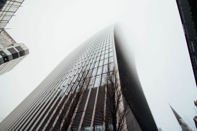 Low Angle View of Tall Skyscrapers Meeting Fog - Download Free Stock Photos Pikwizard.com