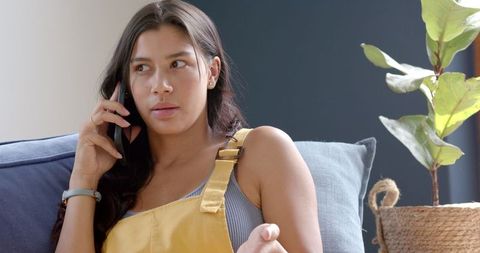 Teen Girl Seriously Discussing on Smartphone at Home