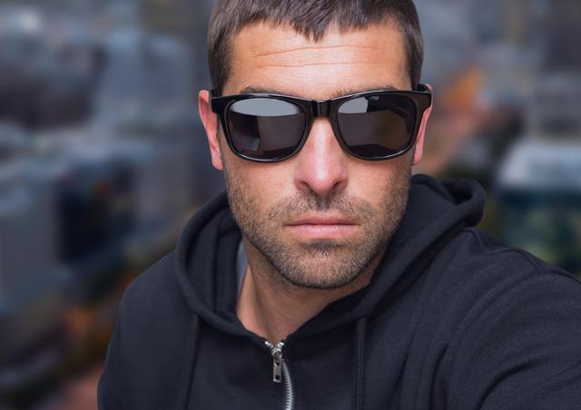 Digital composite of Man with sunglasses in front of city