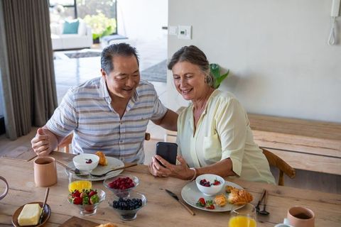 Senior Couple Enjoying Breakfast with Technology