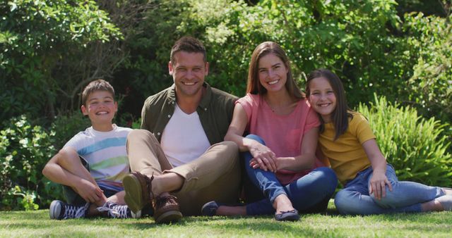 Happy Family Sitting on Green Grass in Sunny Garden - Download Free Stock Images Pikwizard.com