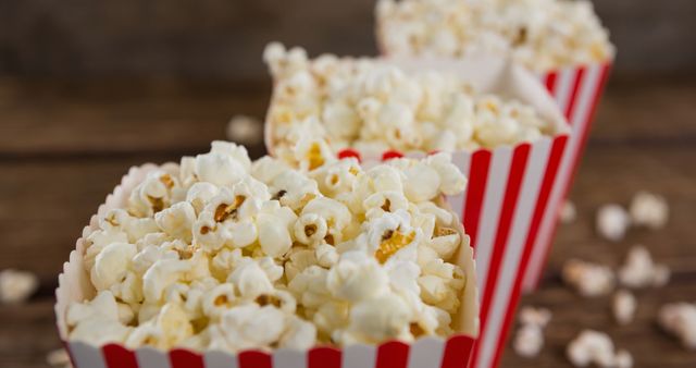 Close-Up of Popcorn Boxes Lined Up on Wooden Table - Download Free Stock Images Pikwizard.com