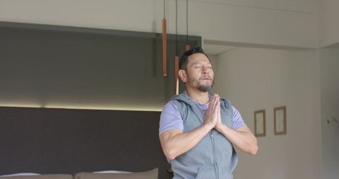 Man Meditating Peacefully in Modern Bedroom Environment