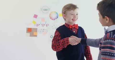 Friendly Handshake Between Two Young Boys in Creative Environment - Download Free Stock Images Pikwizard.com