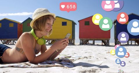 Teenager Engaging with Social Media on Sunny Beach
