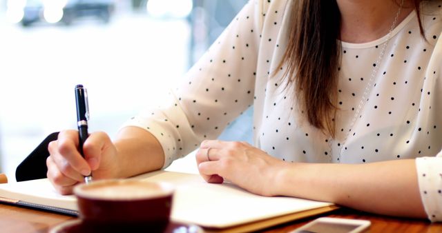 Woman Writing in Notebook at Café Table - Download Free Stock Images Pikwizard.com