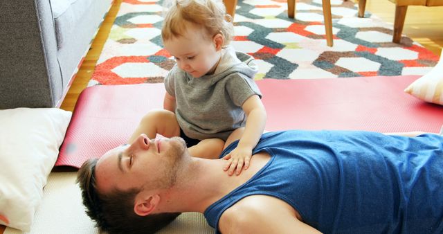 Father and Child Bonding on Living Room Floor with Colorful Rug - Download Free Stock Images Pikwizard.com