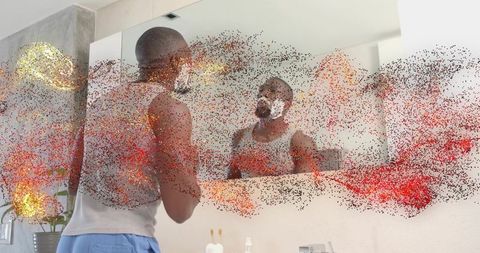 Man shaving at bathroom mirror with foam and dynamic red particle overlay for grooming
