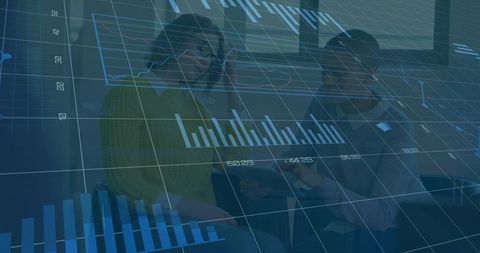 Female coworkers collaborating over tablet with interactive financial charts and dashboard