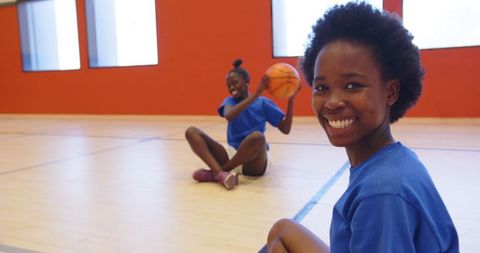 Smiling African American Girls Enjoying Basketball on Indoor Court