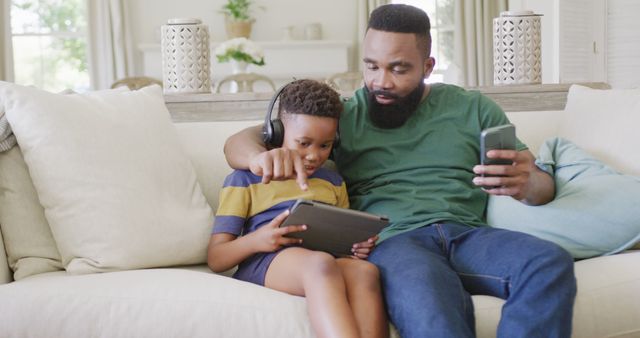 Father and Son Sharing Quality Time with Tablet at Home - Download Free Stock Images Pikwizard.com