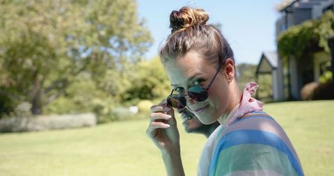 Woman Relaxing in Sunglasses Enjoying Sunny Day Outdoors