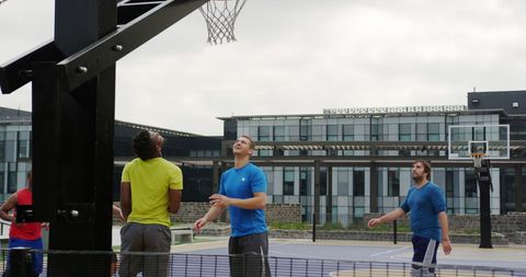 Group of Diverse Players Enjoying Outdoor Basketball Game
