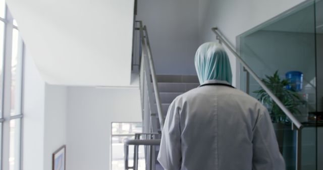 Medical Professional in Lab Coat Climbing Stairs Inside Clinic - Download Free Stock Images Pikwizard.com