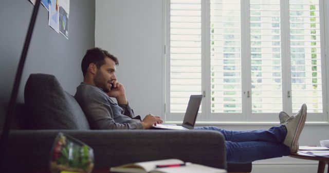 Man Working from Home on Laptop While Talking on Phone - Download Free Stock Images Pikwizard.com