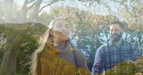 Couple walking through sunlit woods with mountain double exposure, nature lifestyle concept