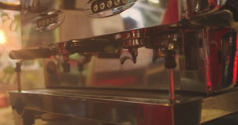 Shiny espresso machine in warm cafe light