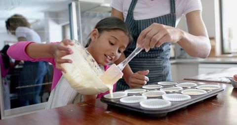 Mother and Daughter Baking Together Joyfully at Home