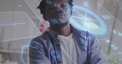 Mid-adult man viewing augmented reality HUD interface in modern creative studio workspace