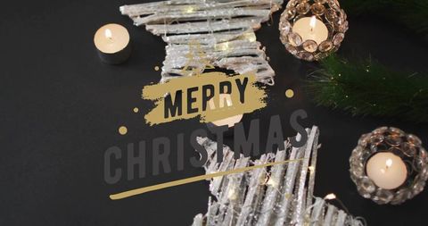 Merry christmas gold brushstroke over silver star ornaments with candlelight glow