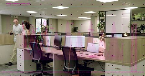 Open-plan office desk row with monitors and laptop, collaborative workspace, data overlay