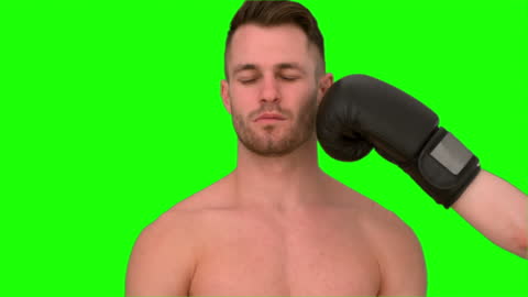 Man Preparing for Punch Against Vibrant Green Screen