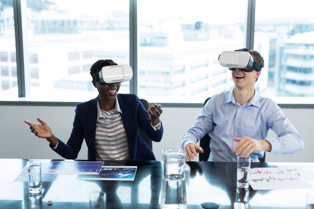 Smiling executives using virtual reality headset in office