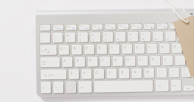Overhead view of brown sale tag on computer keyboard. Global business, communication, online shopping, cyber monday, sale and retail concept digitally generated image.