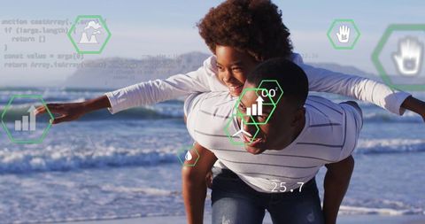 Father giving son piggyback on sunny beach while walking with augmented reality eco hud