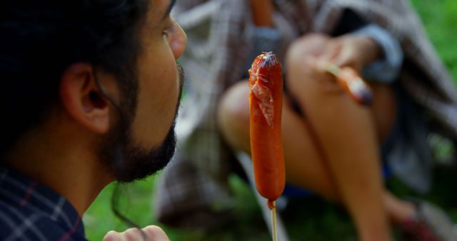 People Enjoying Outdoor Tradition Roasting Sausages on Stick - Download Free Stock Images Pikwizard.com