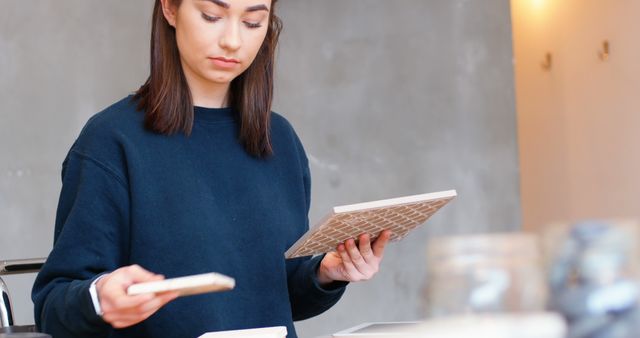 Young Woman Choosing Ceramic Tiles for Home Renovation - Download Free Stock Images Pikwizard.com