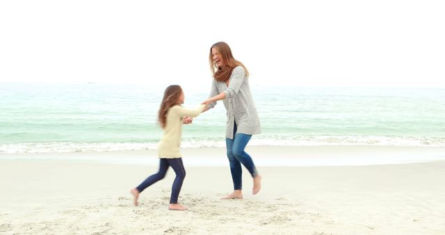 Mother and daughter playing on the beach - Download Free Stock Photos Pikwizard.com