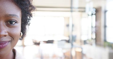 Confident african american woman smiling in modern office environment