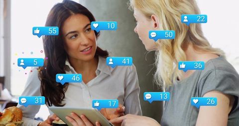 Businesswomen Discussing Digital Metrics in Social Media Strategy Meeting