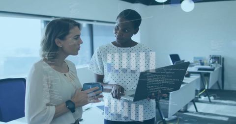 Diverse Female Colleagues Analyzing Financial Data on Laptop