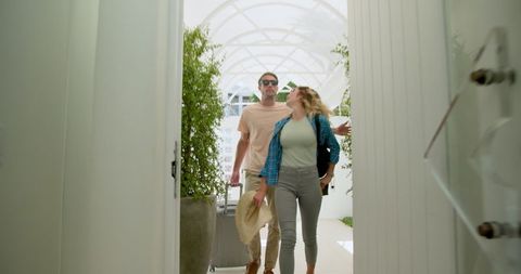 Couple Arriving for Vacation With Luggage and Sunglasses
