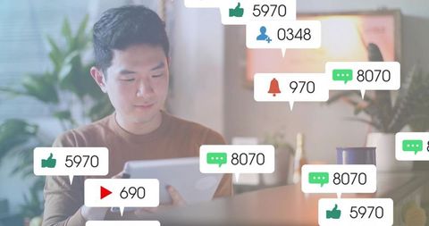 Young Man Engaging with Social Media on Tablet at Home Office