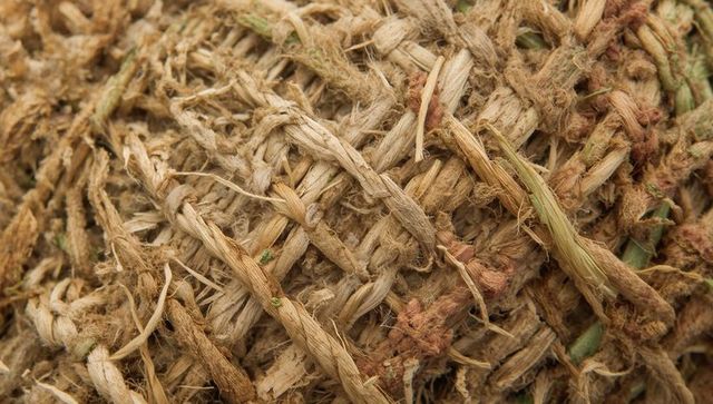 Macro close-up of braided natural fiber rope showing frayed texture for rustic design