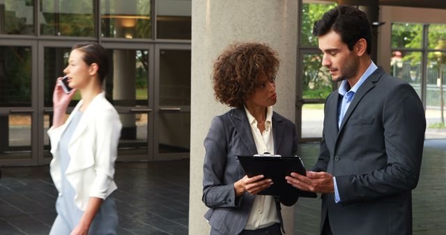 Business Professionals Discussing Paperwork Outside Office Building - Download Free Stock Images Pikwizard.com