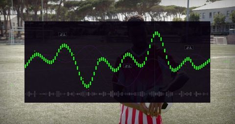 Holding soccer ball with hud analytics overlay tracking player performance football pitch
