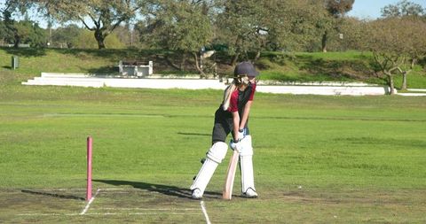 Teenage Girl Cricket Player Batting on Field